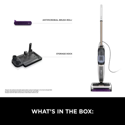Front view of the dark grey Shark SteamPickUp SD200UK hard floor cleaner standing upright on its storage dock over light wood laminate flooring.