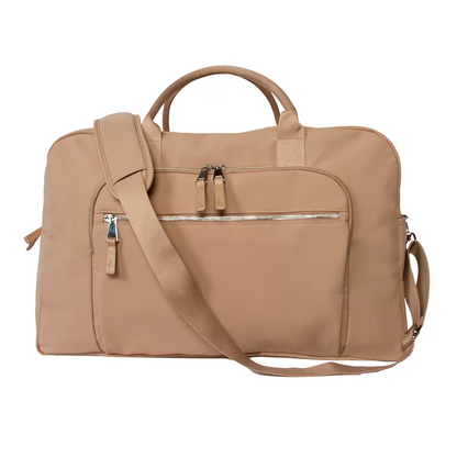 Side view of the water-repellent Shed Rain Weekender Bag showing its textured recycled nylon, exterior zip pockets, and attached trolley sleeve.