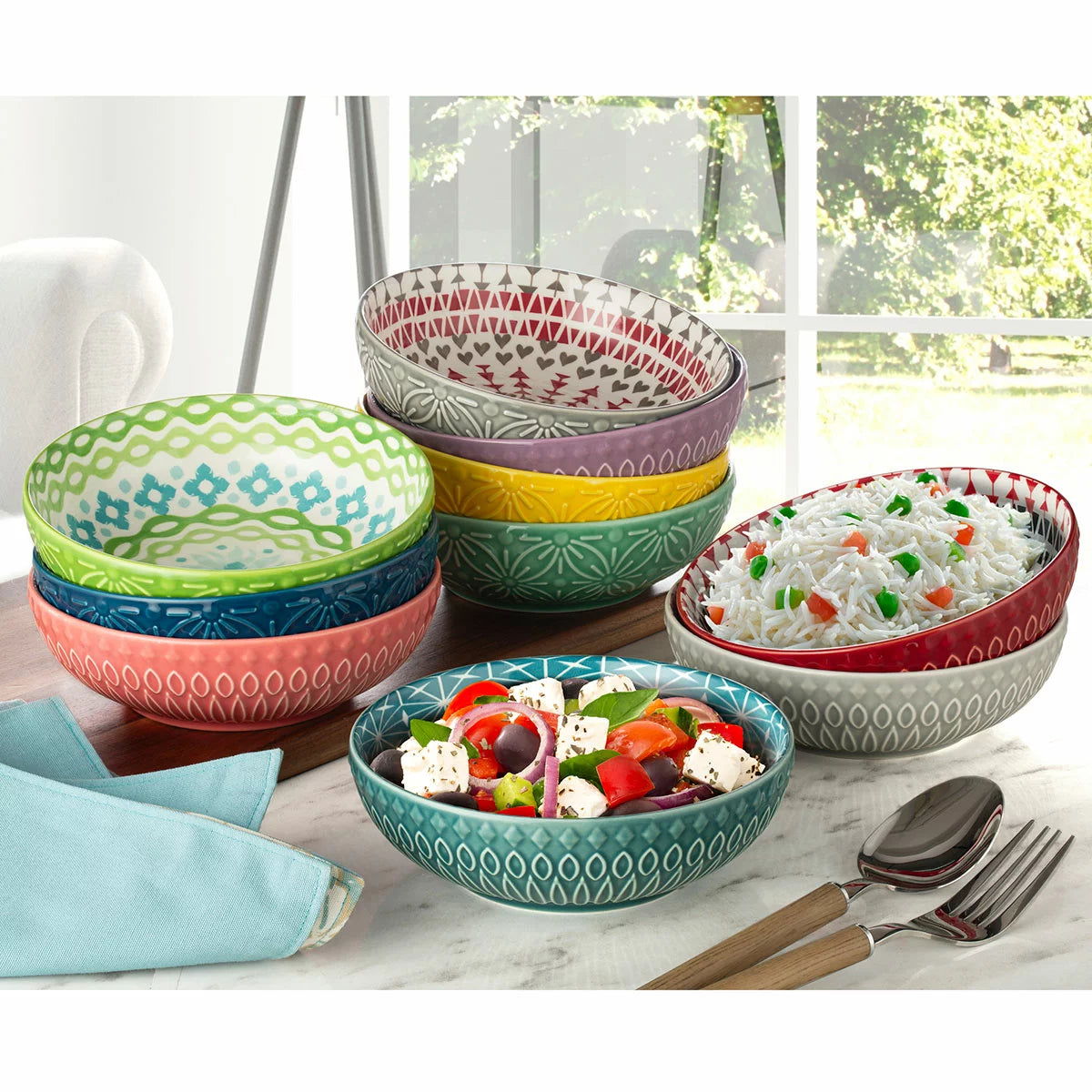 The Signature Housewares Stoneware Bowls 10-Piece Set arranged together, showcasing their vertical stripe patterns and array of ten distinct, vibrant colors.
