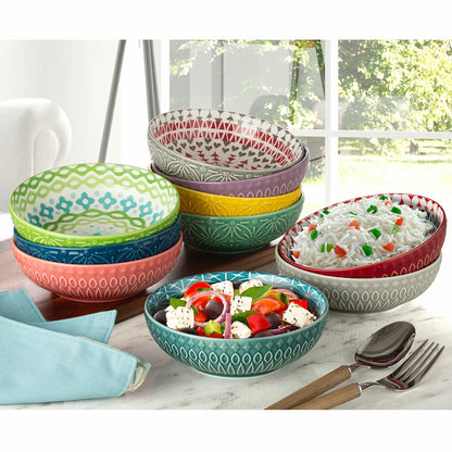 The Signature Housewares Stoneware Bowls 10-Piece Set arranged together, showcasing their vertical stripe patterns and array of ten distinct, vibrant colors.