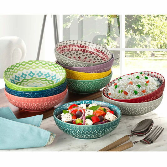 The Signature Housewares Stoneware Bowls 10-Piece Set arranged together, showcasing their vertical stripe patterns and array of ten distinct, vibrant colors.