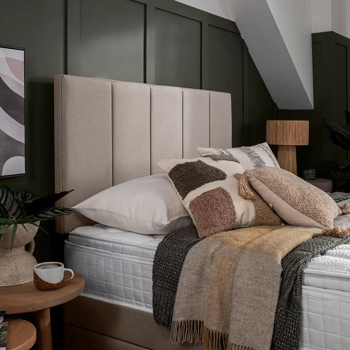 Front view of the 5-panel Silentnight Brescia headboard upholstered in textured sandstone fabric mounted on a divan bed.