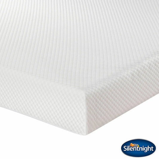 White Silentnight Comfort Memory Plus rolled foam mattress partially unrolled on a modern wooden bed frame in a brightly lit bedroom.