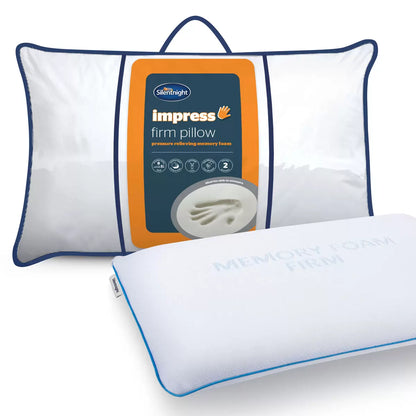 White Silentnight Impress firm memory foam pillow with textured removable cover shown at a three-quarter angle on a modern bed.