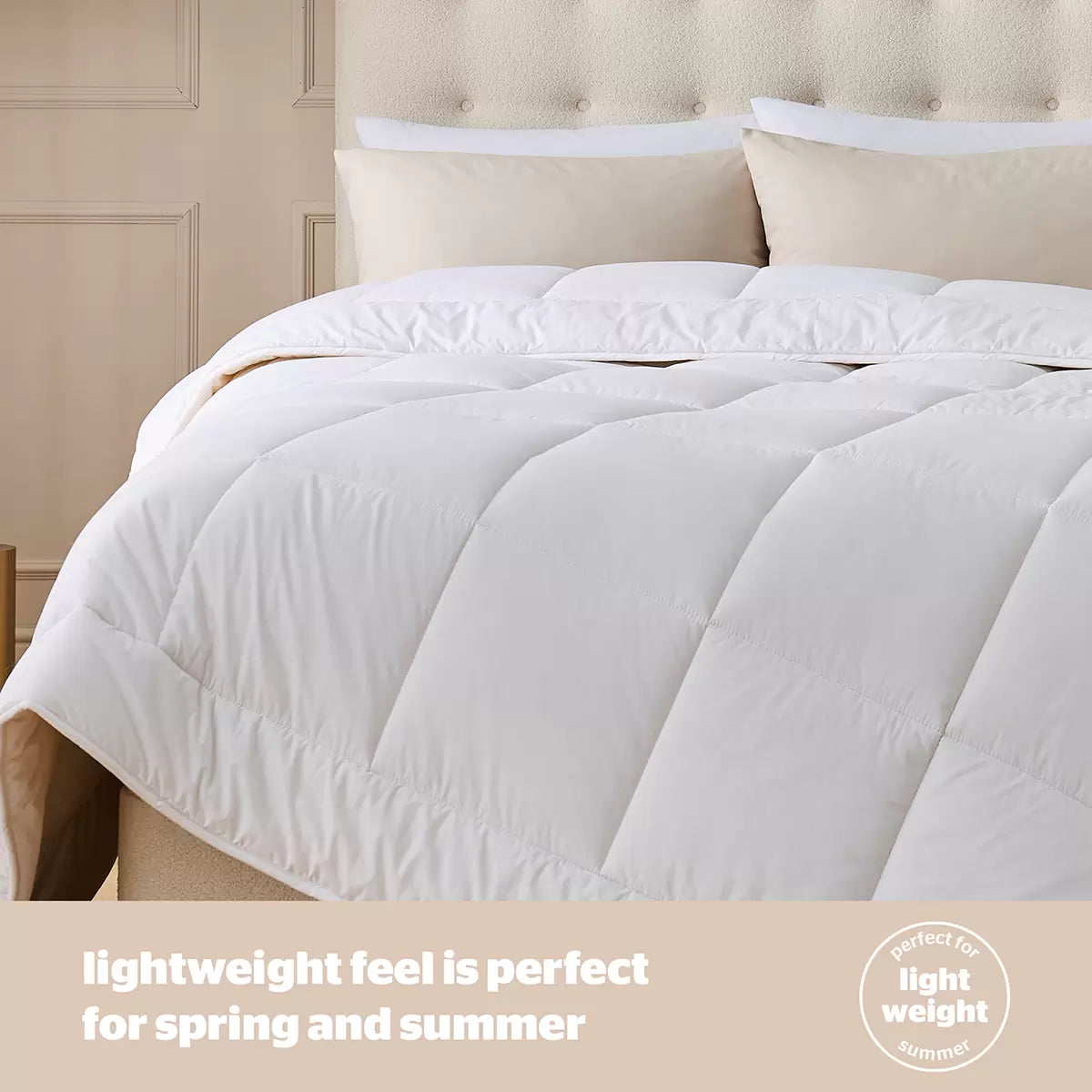 Flat-lay image of the white Silentnight natural wool double duvet with soft 100% cotton stitching resting on a neatly dressed wooden bed.