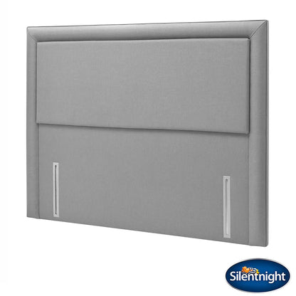 Front view of the slate grey Silentnight Palermo full height fabric headboard with a minimalist bordered frame installed behind a neatly made bed in a contemporary modern bedroom setting.