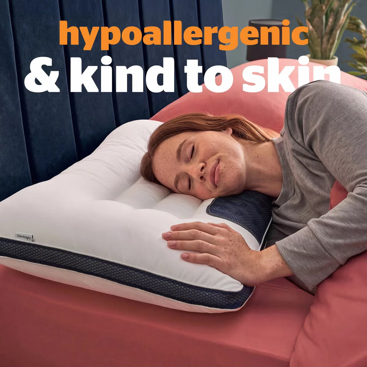 White contoured Silentnight Smart Sleep Magnetic Neck Therapy Pillow with microfibre cover resting on a contemporary bed.