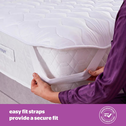 Close-up angled shot of the white Silentnight Deep Sleep Superking Heated Quilted Topper fitted over a mattress with its dual hand controller visible on a bedside table.