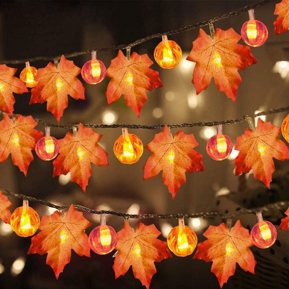 A 19.68ft Sinhoon pumpkin and maple leaf string light glowing with warm LEDs across a festive autumn mantelpiece.