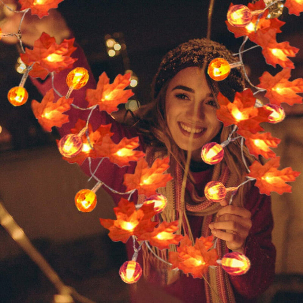 A 19.68ft Sinhoon pumpkin and maple leaf string light glowing with warm LEDs across a festive autumn mantelpiece.