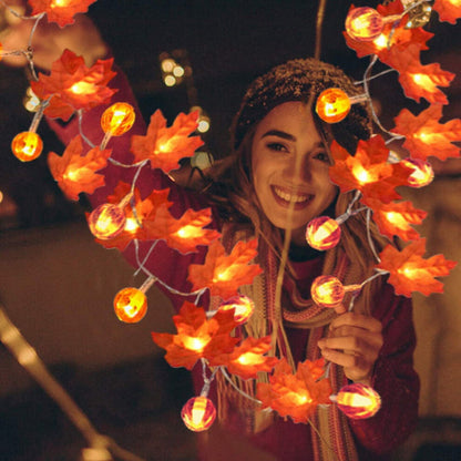 A 19.68ft Sinhoon pumpkin and maple leaf string light glowing with warm LEDs across a festive autumn mantelpiece.