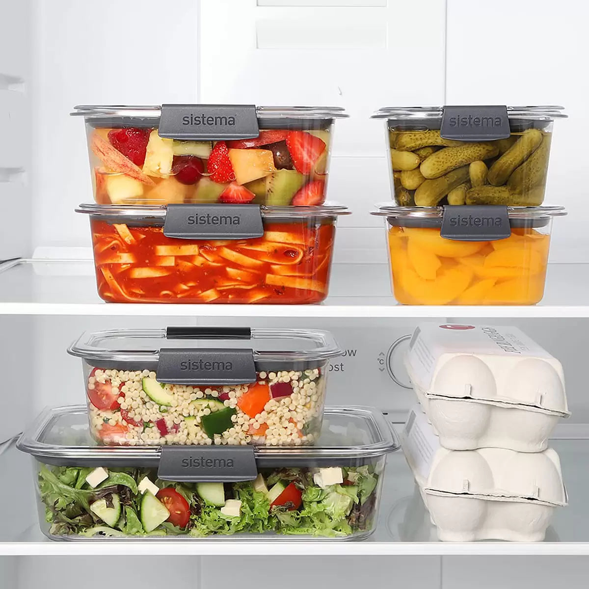 A 14-piece Sistema Brilliance food storage set organized neatly on a kitchen counter, showcasing clear containers and grey leak-proof lids.