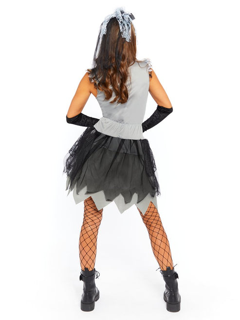 Adult wearing the Skelebride dark gothic dress and veil with printed white skeleton ribs against a shadowy studio backdrop.