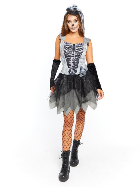 Adult wearing the Skelebride dark gothic dress and veil with printed white skeleton ribs against a shadowy studio backdrop.