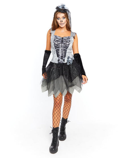 Adult wearing the Skelebride dark gothic dress and veil with printed white skeleton ribs against a shadowy studio backdrop.