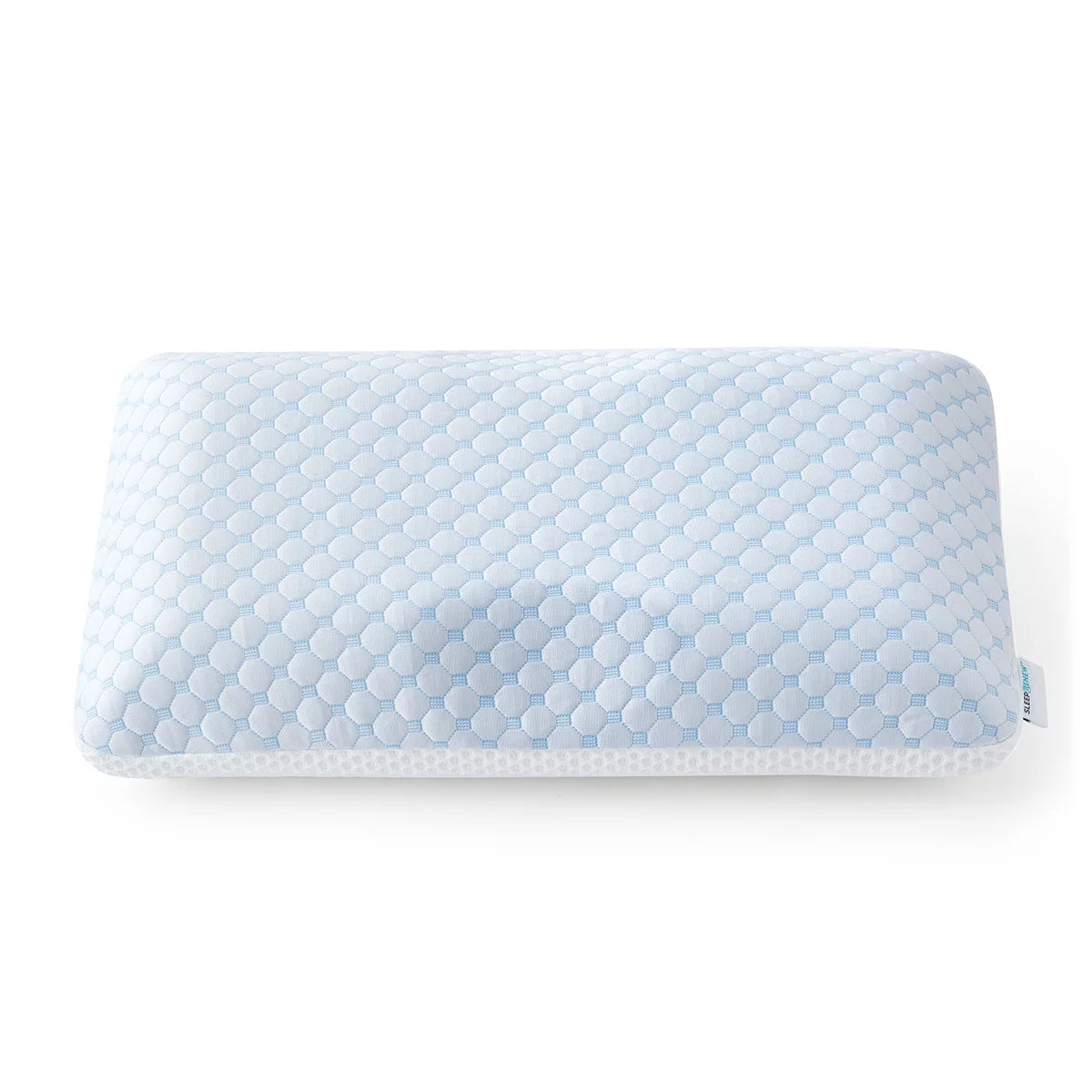 White rectangular dual-sided cooling memory foam pillow displaying textured ventilation pattern on a modern bed setup.