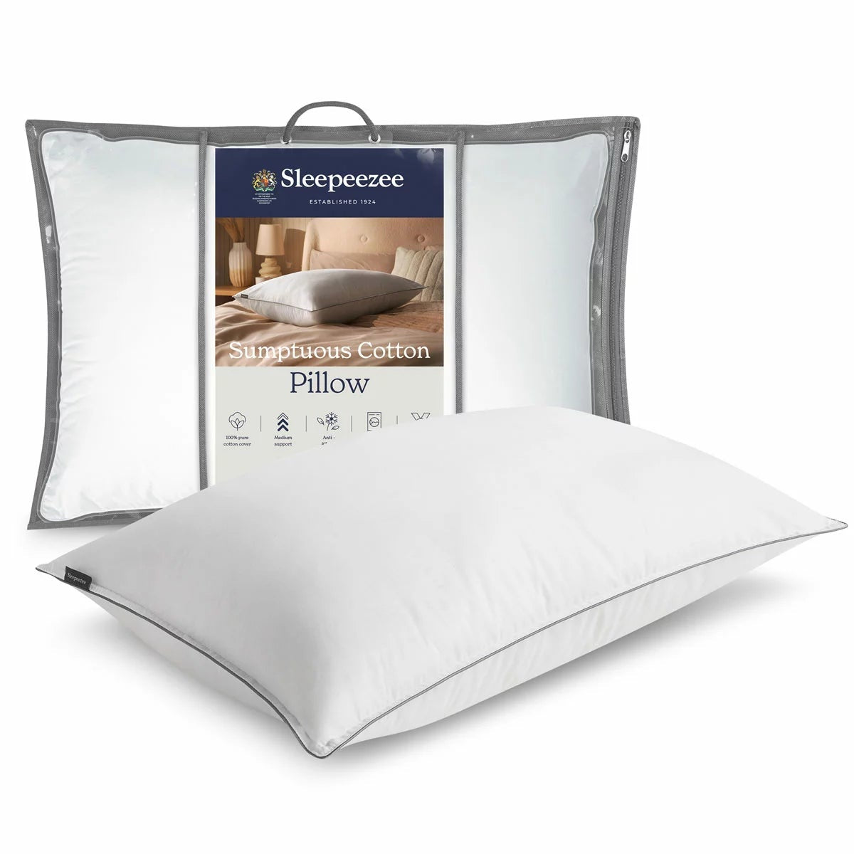 Crisp white Sleepeezee Sumptuous Cotton Pillow with neat piped edges resting on a pristine white bed sheet in a modern bedroom setting.