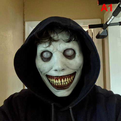 White smiling demon Halloween mask made of flexible latex featuring stark black eye sockets, a wide eerie grin, and red teeth displayed against a neutral background.