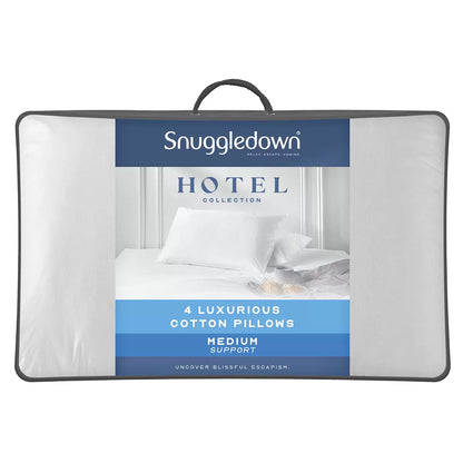Stack of four white Snuggledown Clusterdown Synthetic Pillows showing crisp self-piped cotton edges on a wooden bedroom chest.