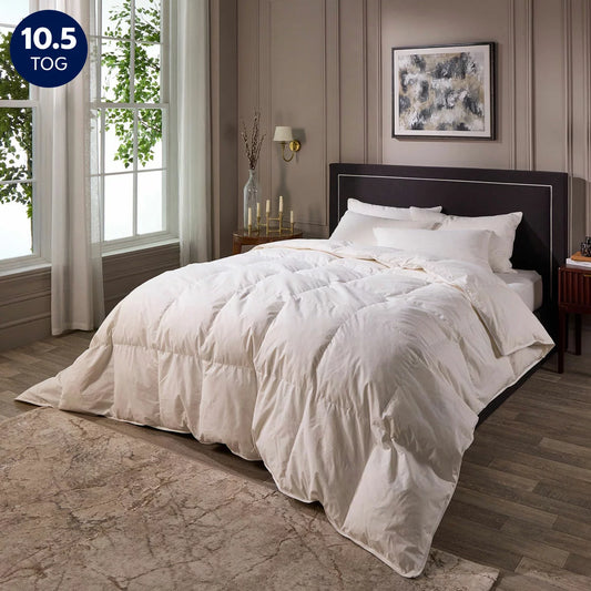 Close-up shot of the white Snuggledown Hotel Signature Goose Feather double duvet featuring double-stitched piping on a styled bed.