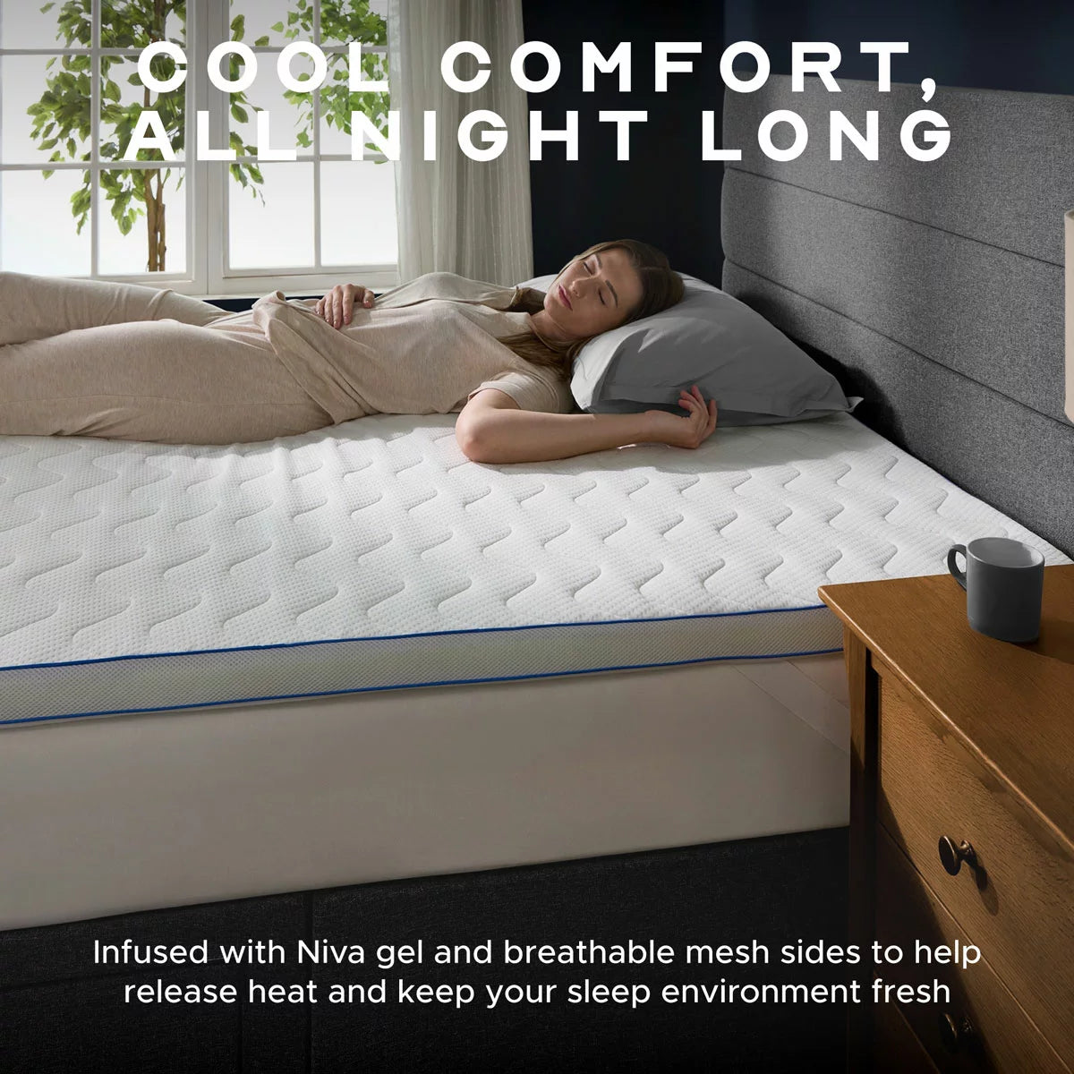 Top-down view of the white Snuggledown King size gel mattress topper on a cozy wooden bed frame, showing the blue Niva cooling gel layer under a breathable mesh-sided polyester cover.