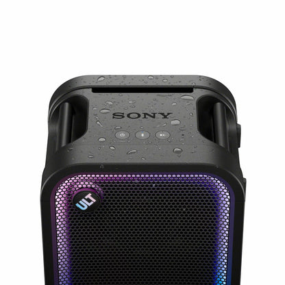 Black Sony ULT500 portable Bluetooth tower speaker with active LED rim lighting shown standing outdoors on a wooden patio deck.