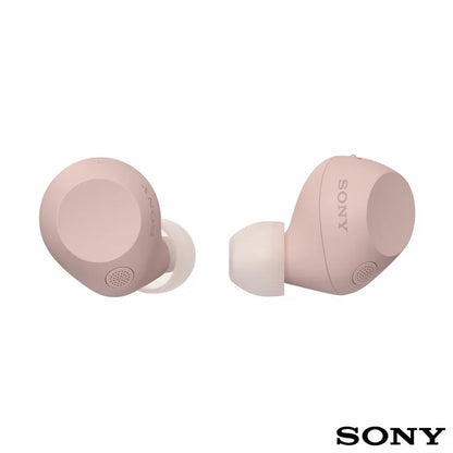 Front angle view of Sony WF-C710N Glass Blue wireless noise cancelling earbuds sitting beside their open charging case on a minimalist wooden desk.
