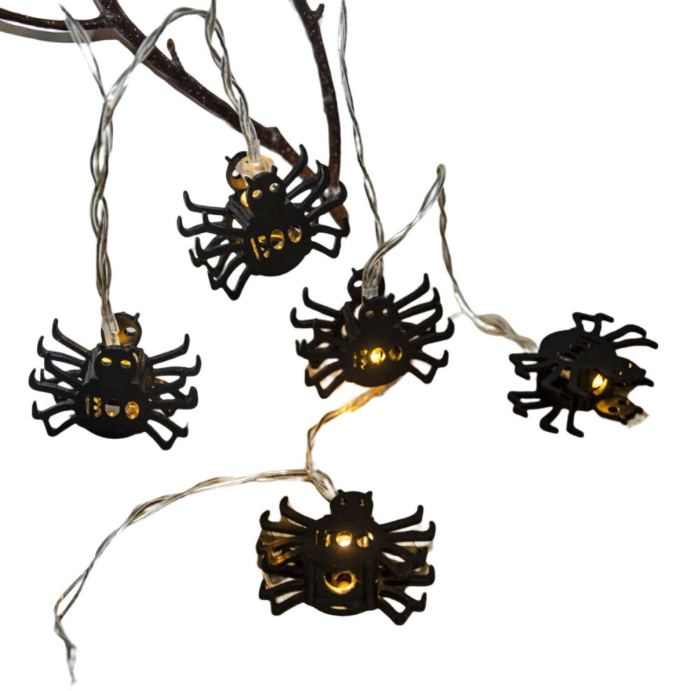 Creative spider LED string lights glowing with a spooky ambiance along an outdoor patio wall.