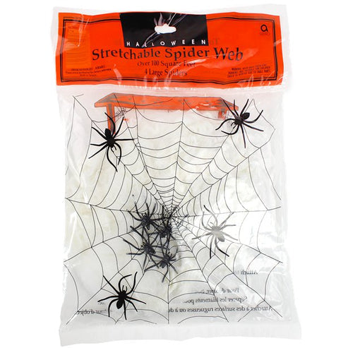 White stretchable synthetic spider web draped across a dark wooden doorframe with four small black plastic spiders embedded in the strands.