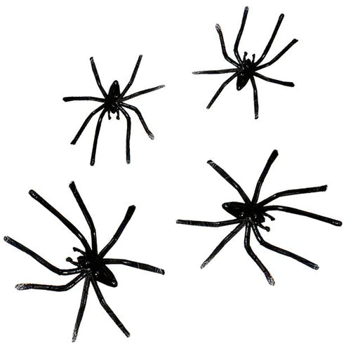 White stretchable synthetic spider web draped across a dark wooden doorframe with four small black plastic spiders embedded in the strands.