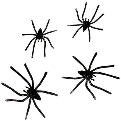 White stretchable synthetic spider web draped across a dark wooden doorframe with four small black plastic spiders embedded in the strands.