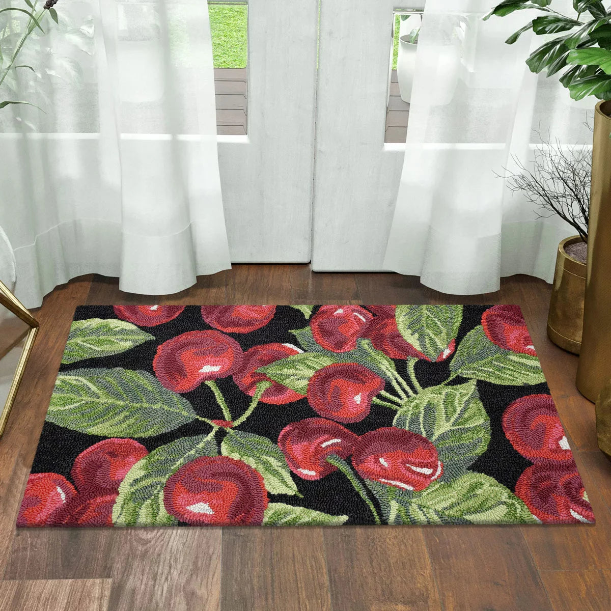 Top-down view of the colourful hand-hooked spring accent rug with textured floral motifs on a light hardwood entryway floor.