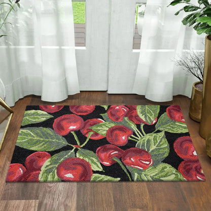 Top-down view of the colourful hand-hooked spring accent rug with textured floral motifs on a light hardwood entryway floor.