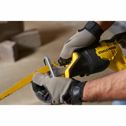 Side profile view of the yellow and black Stanley Fatmax 18V cordless reciprocating saw equipped with a 4Ah V20 battery and cutting blade on a concrete work surface.