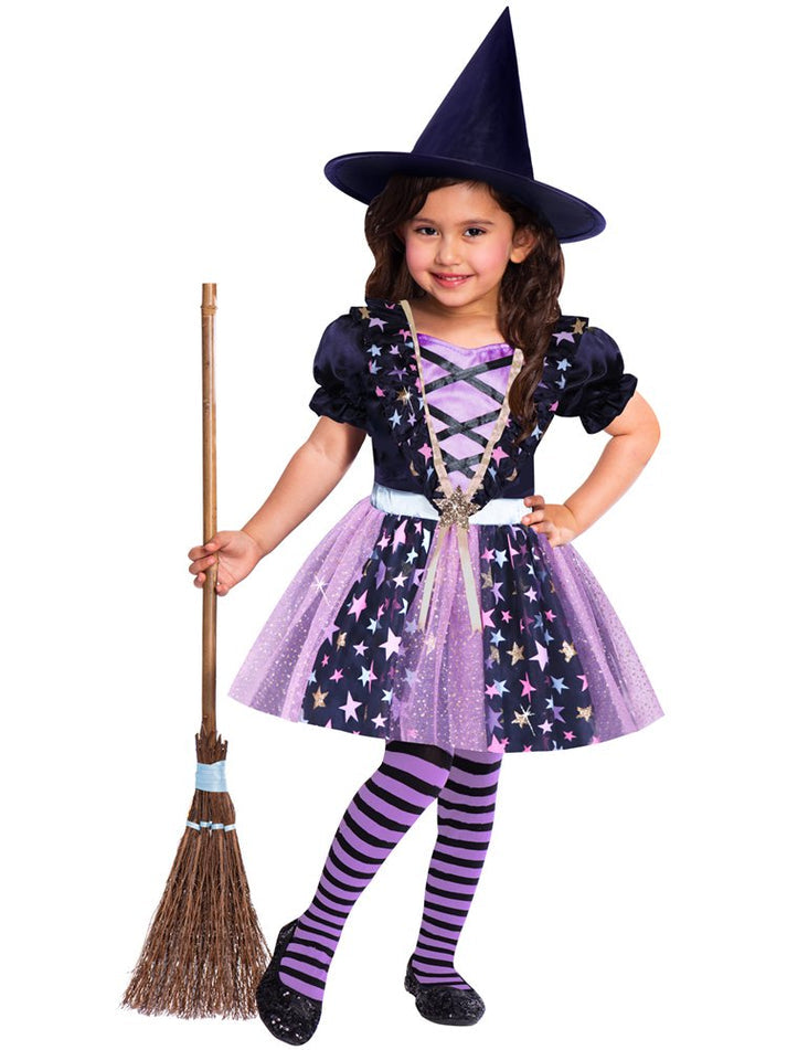 Toddler wearing a black and purple Starlight Witch Costume with silver star accents and a matching pointed hat outdoors.