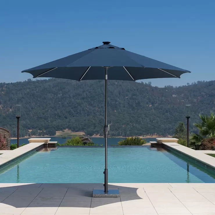 SunVilla 10ft Blue Solar LED Market Umbrella with glowing ribs and solar panel top on a residential patio.