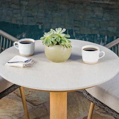 SunVilla Charme 3-Piece Bistro Set featuring honey oak finish chairs and a Permastone round table on a clean patio surface.