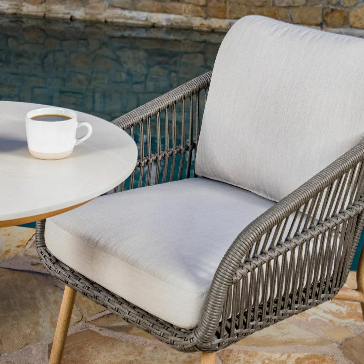 SunVilla Charme 3-Piece Bistro Set featuring honey oak finish chairs and a Permastone round table on a clean patio surface.