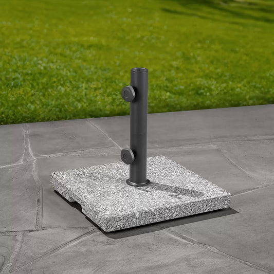 Polished SunVilla Pembrooke Granite Umbrella Base with a stainless steel pole holder on a stone patio.