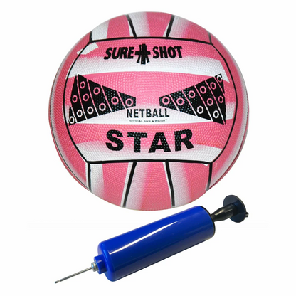 Pink and grey Sure Shot 9ft Prime Shot junior netball goal standing on a brick patio with its pink pole pad installed and an included netball resting near the base.