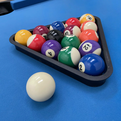 Three-quarter overview of the black Sure Shot Elite Pro 7ft Pool Table showing its green cloth surface, polished chrome corner caps, and large adjustable feet set on a grey modern flooring.