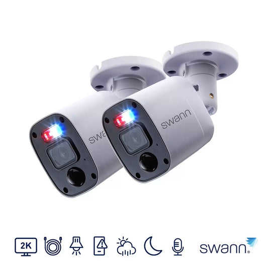 Pair of white Swann 2K bullet add-on security cameras with integrated red and blue warning lights displayed alongside mounting screws and BNC cabling.