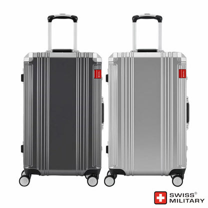 Angle view of the silver and dark grey Swiss Military 63.5cm hardside suitcase showing its aluminium edge frame and double urethane wheels on a light surface.
