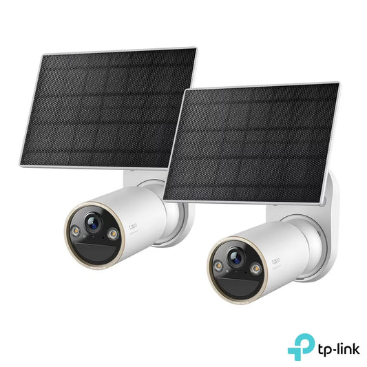 Pair of white TP-Link Tapo C460KIT 4K solar security cameras mounted on exterior wall magnetic bases with compact connected solar panels facing upward.