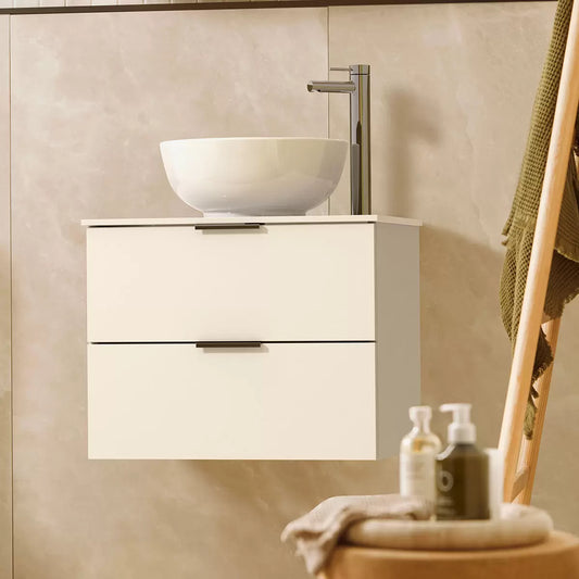 Front angle view of the Tavistock Vesta gloss white wall-mounted bathroom vanity unit featuring two pulled-open soft-close drawers, a clean white ceramic vessel basin, and sleek chrome top handles in a modern tiled bathroom setting.