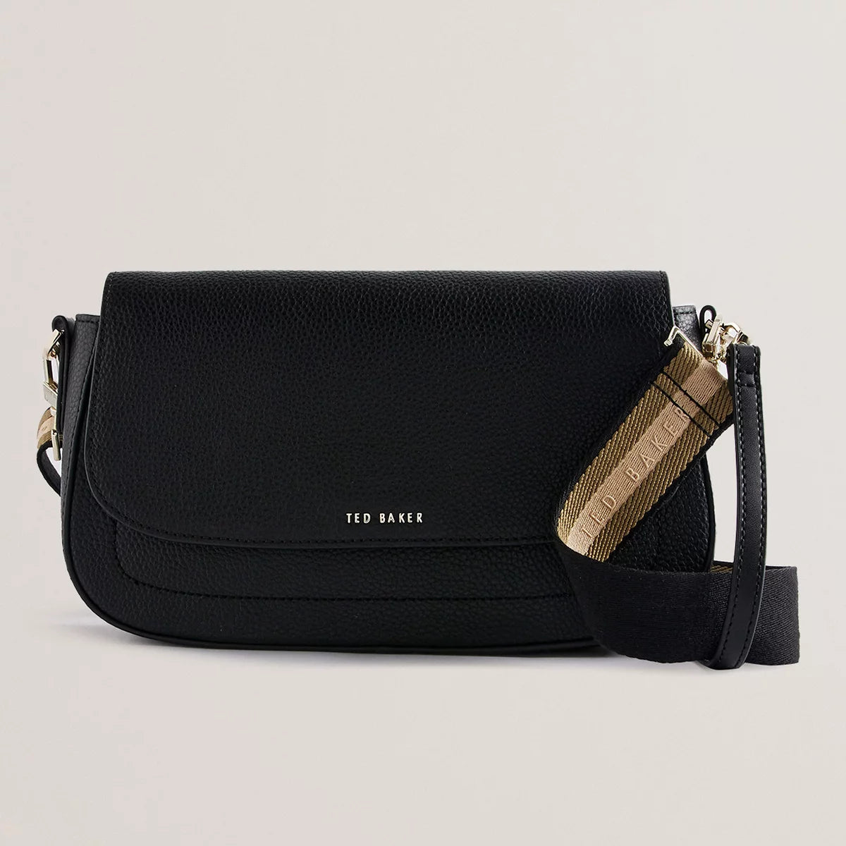 Ted Baker Darilie crossbody bag in grained leather with gold-tone logo hardware and adjustable shoulder strap.
