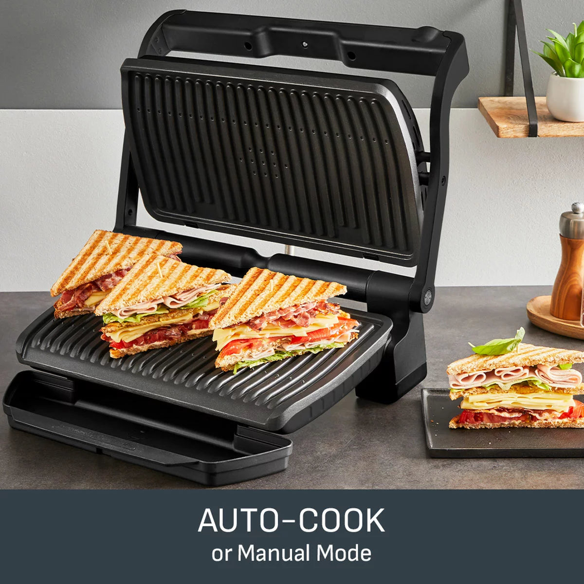 The Tefal OptiGrill XL in Matt Black sitting on a clean kitchen surface, showing the colour-coded cooking progress display and large grilling area.