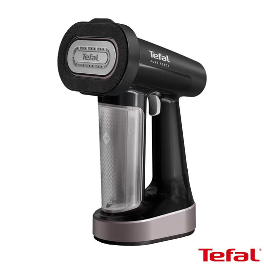 Tefal Pure Force 3-in-1 handheld garment steamer in dark metallic blue with reversible lint pad attached, shown on a table.