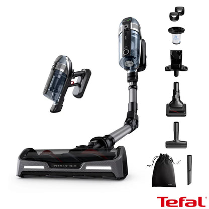 Front view of the Black & Grey Tefal X-Force Flex cordless stick vacuum mounted on its wall base with included pet accessories nearby.