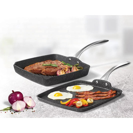 Starfrit The Rock 2-piece cookware set displaying a dark grey 26cm square grill pan with pour spouts alongside a 28cm round griddle pan with stainless handles on a stone countertop.